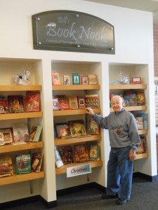 Bill standing in front of the book nook at the Harnish library